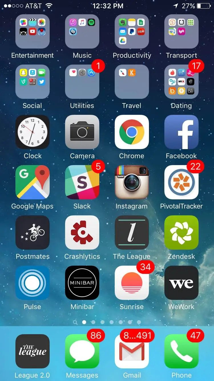 A conventional iPhone home screen, in full colour and crowded with app icons and folders, several carrying red notification badges, including one showing 17 and a mail icon showing hundreds.